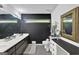 Well-lit bathroom featuring a vanity with double sinks, toilet, and decorative shelving at 2451 Cedar Fork Trl, Marietta, GA 30062