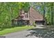 Charming exterior with a well-maintained lawn and a two-car garage nestled amongst the trees at 2451 Cedar Fork Trl, Marietta, GA 30062