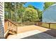 Wooden back deck featuring wooden railing and steps in a fenced back yard at 3612 River Mill Ct, Ellenwood, GA 30294