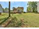 Large backyard featuring a deck and manicured lawn at 3612 River Mill Ct, Ellenwood, GA 30294