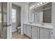 Double sink vanity bathroom featuring tile flooring and natural light at 3612 River Mill Ct, Ellenwood, GA 30294