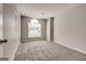 Bedroom features neutral walls, plush carpet, arched window, and closet space at 3612 River Mill Ct, Ellenwood, GA 30294