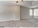 Spacious bedroom featuring neutral walls, plush carpeting, and large windows for ample natural light at 3612 River Mill Ct, Ellenwood, GA 30294