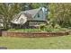 Community entrance sign for River Mill with a manicured lawn and shrubbery at 3612 River Mill Ct, Ellenwood, GA 30294