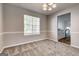 Dining room showcasing neutral paint, chair rail, plush carpeting, and a view into the kitchen at 3612 River Mill Ct, Ellenwood, GA 30294
