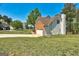 View of the home's exterior highlighting brick and siding details, garage, and lawn at 3612 River Mill Ct, Ellenwood, GA 30294