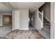Foyer features neutral paint, stone floors, a staircase and entry to living spaces at 3612 River Mill Ct, Ellenwood, GA 30294