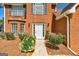 Close-up of brick facade, front door, and manicured landscaping at 3612 River Mill Ct, Ellenwood, GA 30294