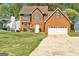 Charming two-story brick home with well-maintained lawn and attached two-car garage at 3612 River Mill Ct, Ellenwood, GA 30294