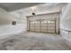 Spacious two car garage featuring a white door and concrete floor at 3612 River Mill Ct, Ellenwood, GA 30294