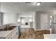 Open kitchen with stainless appliances, marbled countertops, and a view into the living area at 3612 River Mill Ct, Ellenwood, GA 30294