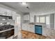 Updated kitchen with stainless appliances, white cabinets, marbled countertops, and view to a breakfast nook at 3612 River Mill Ct, Ellenwood, GA 30294