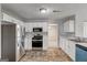 Well-equipped kitchen featuring stainless appliances, white cabinets, and easy access to dining area at 3612 River Mill Ct, Ellenwood, GA 30294