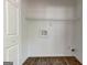 Utility closet with shelf, washer hookup, and plank flooring at 3612 River Mill Ct, Ellenwood, GA 30294