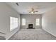 Spacious living room with a fireplace, ceiling fan, and lots of natural light at 3612 River Mill Ct, Ellenwood, GA 30294