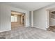 Open-concept living room flows into dining area, showcasing neutral colors and carpeting at 3612 River Mill Ct, Ellenwood, GA 30294
