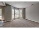 Bright living room featuring large bay windows that provide natural light and plush carpeting at 3612 River Mill Ct, Ellenwood, GA 30294