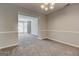 Spacious living room showcasing neutral paint, plush carpeting, and a view into the adjacent sitting room at 3612 River Mill Ct, Ellenwood, GA 30294
