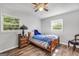 Cozy bedroom with two windows, a ceiling fan, and wood look floors at 736 Stagecoach Rd, Stockbridge, GA 30281
