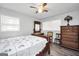 Charming bedroom featuring wood floors, a ceiling fan and lots of natural light at 736 Stagecoach Rd, Stockbridge, GA 30281