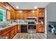 Spacious kitchen with wood cabinetry, updated appliances, and laminate flooring at 736 Stagecoach Rd, Stockbridge, GA 30281