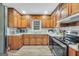 Well-lit kitchen featuring wooden cabinets, modern appliances, and laminate flooring at 736 Stagecoach Rd, Stockbridge, GA 30281