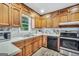 Traditional kitchen featuring wood cabinets, updated appliances, and plenty of counter space at 736 Stagecoach Rd, Stockbridge, GA 30281