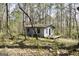 This property features wooded acreage with an old structure at 736 Stagecoach Rd, Stockbridge, GA 30281