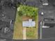 Aerial view of home with a landscaped yard, mature trees, and a long driveway at 121 Cotton Indian Trl, Stockbridge, GA 30281