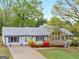 Aerial view of lovely one-story home with landscaped front yard, stone accents, and a long driveway at 121 Cotton Indian Trl, Stockbridge, GA 30281