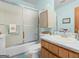Clean bathroom features a frosted shower door, light blue walls, and a wood vanity at 121 Cotton Indian Trl, Stockbridge, GA 30281