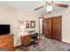 This home has a cozy bedroom with a ceiling fan, desk, and wood-look accents at 121 Cotton Indian Trl, Stockbridge, GA 30281