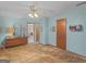 Simple bedroom with a dresser, closet and door that lead to other rooms in the home at 121 Cotton Indian Trl, Stockbridge, GA 30281