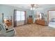 Cozy bedroom featuring a dresser, chair, and natural light from the window at 121 Cotton Indian Trl, Stockbridge, GA 30281