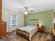 Bright bedroom with a ceiling fan, large window, and comfortable queen bed at 121 Cotton Indian Trl, Stockbridge, GA 30281