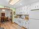 Bright kitchen with white appliances, light countertops, and access to adjacent dining area at 121 Cotton Indian Trl, Stockbridge, GA 30281