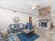 Comfortable living room with a stone fireplace, ceiling fan and plenty of natural light at 121 Cotton Indian Trl, Stockbridge, GA 30281