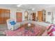 Spacious living room featuring plush seating, a decorative rug, and multiple entryways at 121 Cotton Indian Trl, Stockbridge, GA 30281
