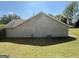 View of the back of the house showing siding and grassy lawn at 10119 Commons Way, Jonesboro, GA 30238