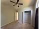 Bedroom with neutral walls, carpet, ceiling fan and closet, offering a simple and clean aesthetic at 10119 Commons Way, Jonesboro, GA 30238