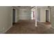 Dining room with plush carpet, neutral walls, and view of the front entrance at 10119 Commons Way, Jonesboro, GA 30238