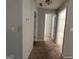 Hallway featuring neutral paint and carpet leading to bedrooms at 10119 Commons Way, Jonesboro, GA 30238