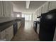 Spacious kitchen with black appliances, light countertops, and tile flooring at 10119 Commons Way, Jonesboro, GA 30238