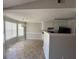 Bright kitchen with tiled floor, a breakfast nook with large windows, and well-lit upper cabinets at 10119 Commons Way, Jonesboro, GA 30238