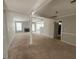 Open-concept living room with plush carpeting, a fireplace, and ample natural light, perfect for gatherings at 10119 Commons Way, Jonesboro, GA 30238
