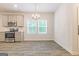 Dining area with stainless steel appliances, hardwood floors, and a chandelier-style light fixture at 5318 Tolar Rd # 25, South Fulton, GA 30213