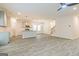 Spacious living area featuring wood-look flooring connecting kitchen and staircase at 5318 Tolar Rd # 25, South Fulton, GA 30213