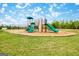 Community playground with swings, slides, and climbing wall on a manicured lawn with mulch at 5318 Tolar Rd # 25, South Fulton, GA 30213