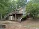 Exterior view of a house with a large deck and stairs leading to the backyard at 191 Tumlin Creek Rd # 1, Roopville, GA 30170