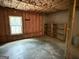 Unfinished basement with concrete floor, insulation, a window, and built-in shelving at 191 Tumlin Creek Rd # 1, Roopville, GA 30170